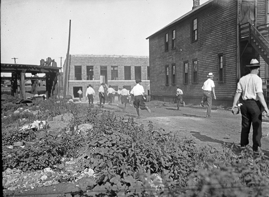 Mob running with bricks during Chicago Race Riots of 1919